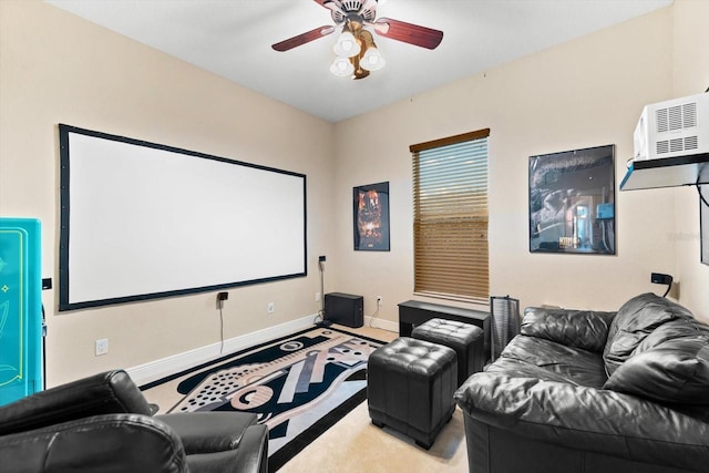 home theater room with a wall unit AC and ceiling fan