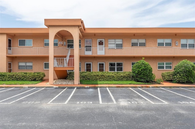 view of property featuring uncovered parking