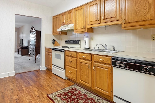 kitchen with carpet floors, sink, decorative backsplash, and white appliances