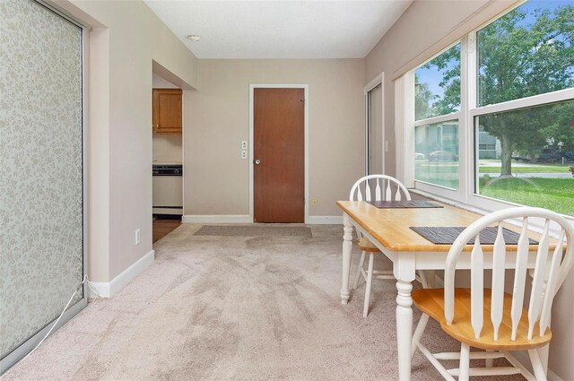 dining area featuring light colored carpet