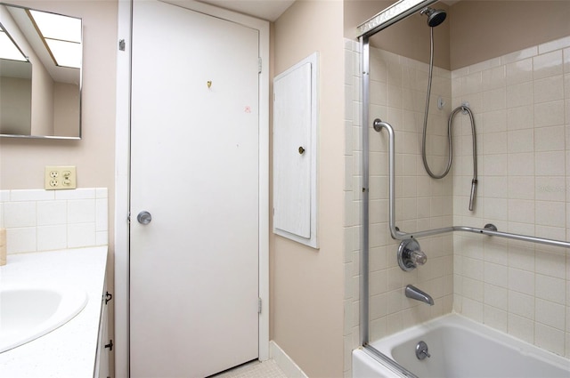 bathroom featuring tiled shower / bath and vanity