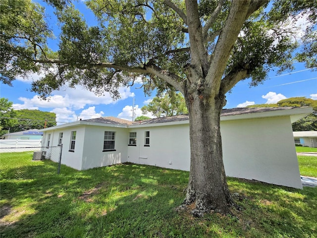 rear view of house featuring a lawn