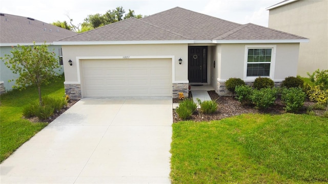 ranch-style home featuring a garage, stone siding, driveway, roof with shingles, and a front lawn