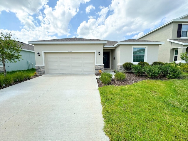 view of front of property featuring a garage, stone siding, driveway, and stucco siding