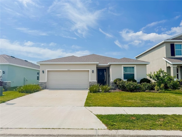 10827 Charlotte Dr, Parrish, FL 34219 - ranch-style home featuring a garage, stone siding, a front yard, stucco siding, and driveway
