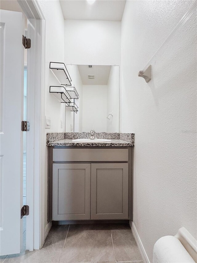 10827 Charlotte Dr, Parrish, FL 34219 - bathroom featuring tile patterned floors, baseboards, and vanity