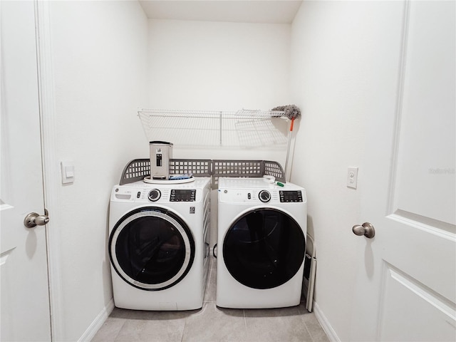 10827 Charlotte Dr, Parrish, FL 34219 - clothes washing area featuring independent washer and dryer, light tile patterned flooring, laundry area, and baseboards