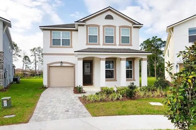 view of front of property featuring a garage and a front lawn