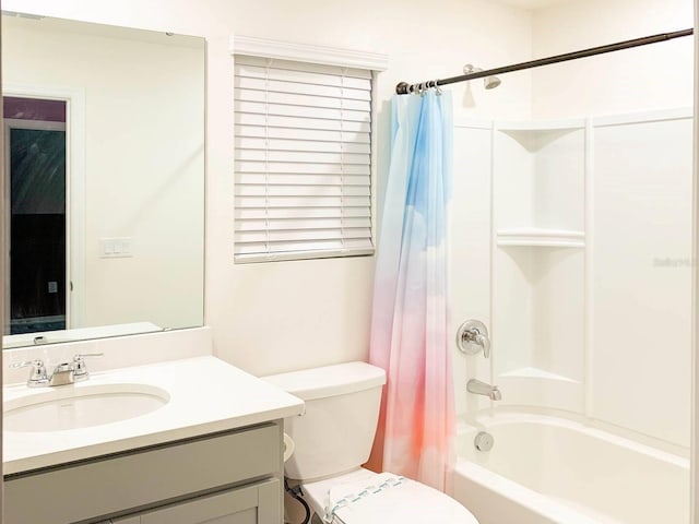 full bathroom featuring toilet, shower / bath combo with shower curtain, and vanity