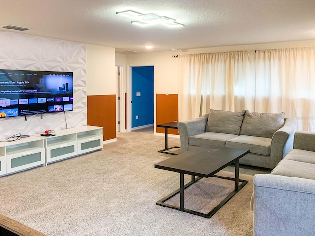 carpeted living room featuring a textured ceiling