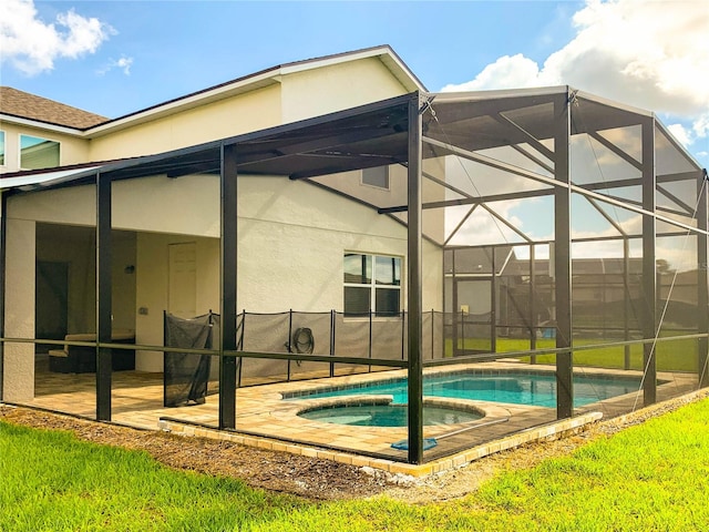 view of pool with glass enclosure and a patio