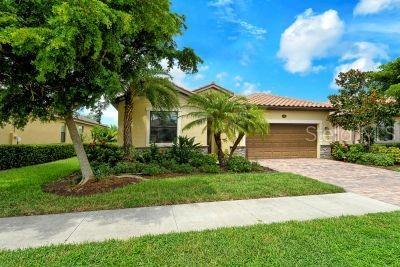 20635 Romagna Pl, Venice, FL 34293 - view of front of home with a garage, driveway, a front yard, and stucco siding