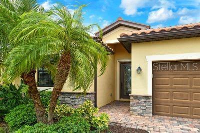 20635 Romagna Pl, Venice, FL 34293 - property entrance with stucco siding and a garage