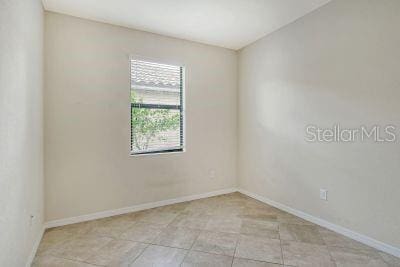 empty room with light tile patterned flooring