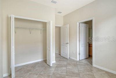 unfurnished bedroom featuring light tile patterned flooring and a closet