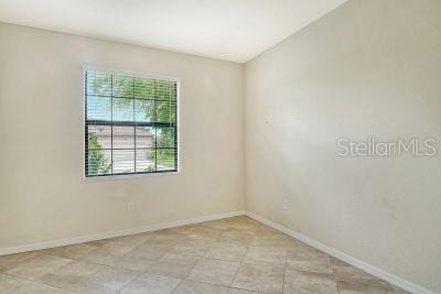 20635 Romagna Pl, Venice, FL 34293 - unfurnished room with baseboards and light tile patterned flooring