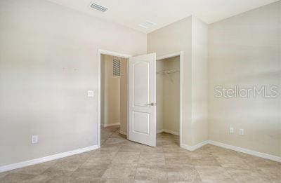 unfurnished bedroom with a closet and light tile patterned flooring