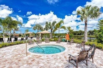 view of pool with a hot tub and a patio area