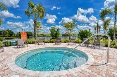 view of swimming pool featuring a hot tub and a patio area