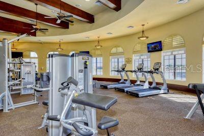 20635 Romagna Pl, Venice, FL 34293 - exercise room with beamed ceiling, carpet, and a ceiling fan