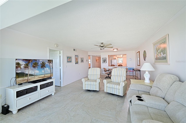 living room with ceiling fan and a textured ceiling