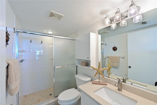 bathroom with vanity, toilet, and an enclosed shower