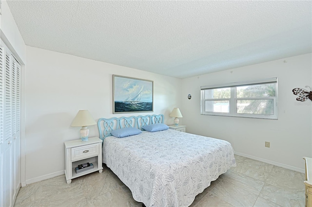 bedroom with a closet and a textured ceiling