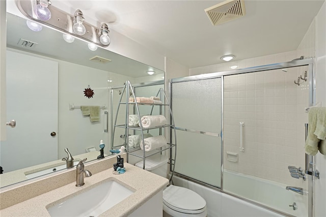 full bathroom with vanity, toilet, and enclosed tub / shower combo