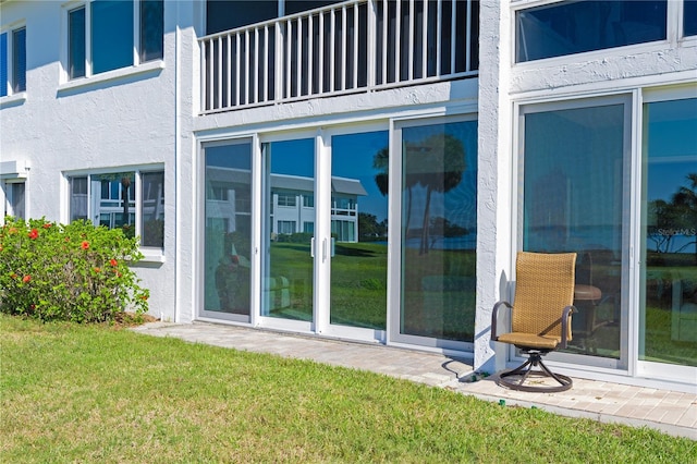 exterior space featuring a balcony and a yard