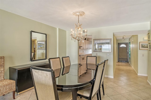 tiled dining space with an inviting chandelier