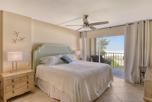 19 Whispering Sands Dr Unit 204, Sarasota, FL 34242 - bedroom with access to outside, light tile patterned floors, a water view, and a ceiling fan