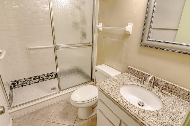 bathroom with tile patterned floors, vanity, walk in shower, and toilet