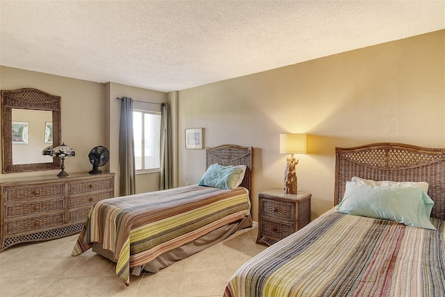 bedroom featuring light tile patterned floors and a textured ceiling