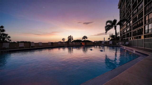 view of pool at dusk