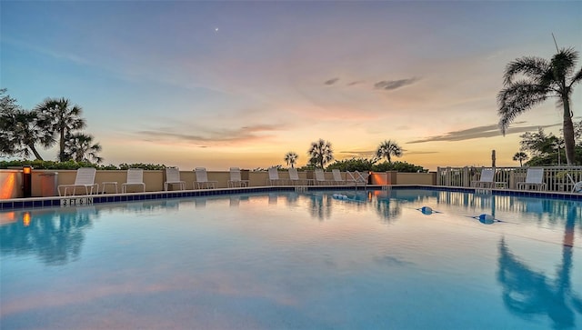 view of pool at dusk