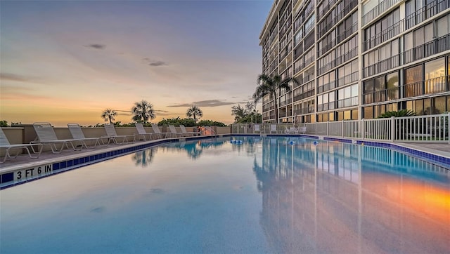 view of pool at dusk