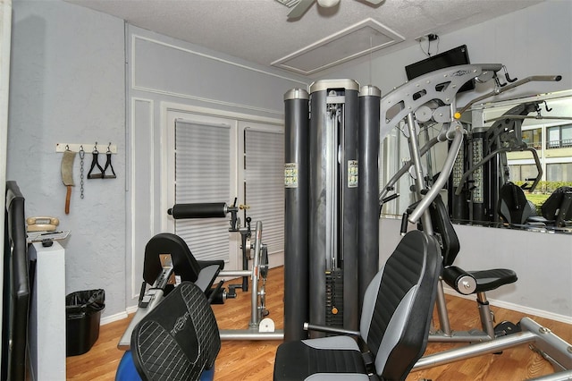 19 Whispering Sands Dr Unit 204, Sarasota, FL 34242 - exercise room featuring attic access, wood finished floors, and a ceiling fan