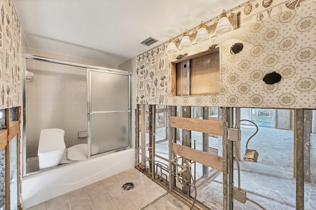 bathroom featuring tile patterned floors and bath / shower combo with glass door