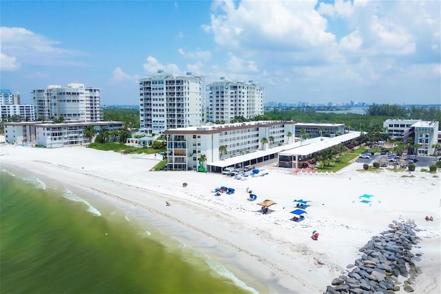 bird's eye view with a water view and a beach view