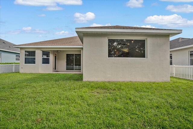 rear view of house with a lawn