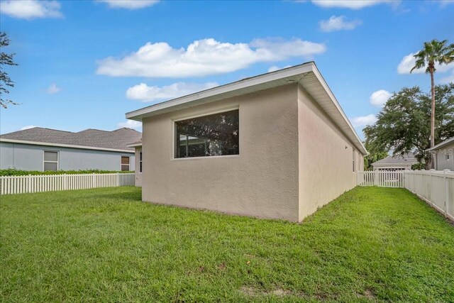 view of side of home featuring a lawn