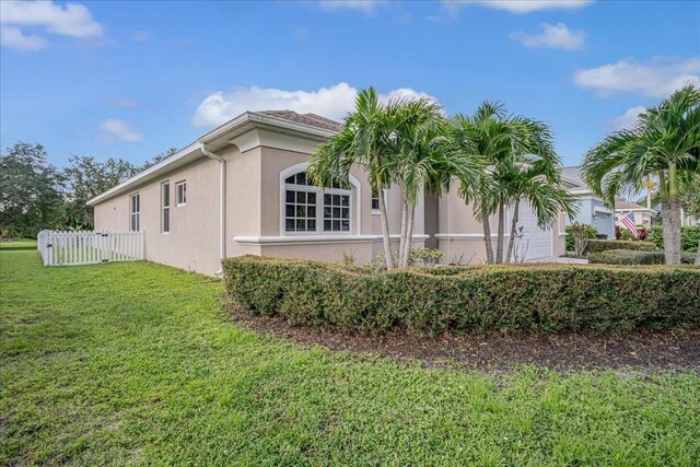 view of side of home with a yard