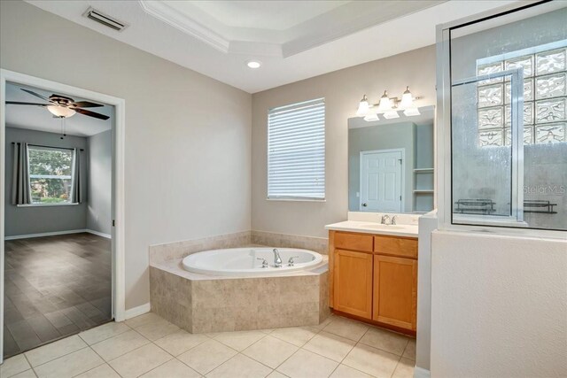 bathroom featuring tiled tub, hardwood / wood-style floors, ornamental molding, vanity, and ceiling fan