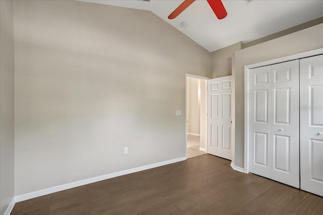 unfurnished bedroom with a closet, ceiling fan, high vaulted ceiling, and wood-type flooring