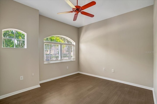 unfurnished room featuring high vaulted ceiling, ceiling fan, a healthy amount of sunlight, and dark hardwood / wood-style flooring