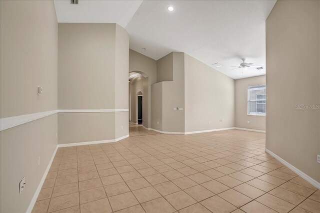 tiled spare room featuring ceiling fan and lofted ceiling