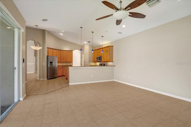 kitchen with kitchen peninsula, vaulted ceiling, light tile patterned flooring, and stainless steel appliances