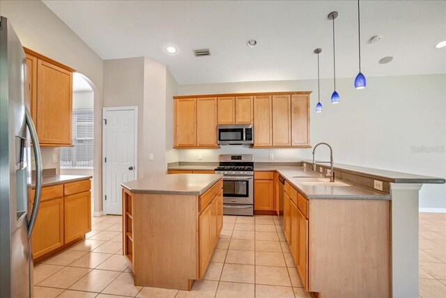 kitchen featuring sink, appliances with stainless steel finishes, pendant lighting, and light tile patterned floors