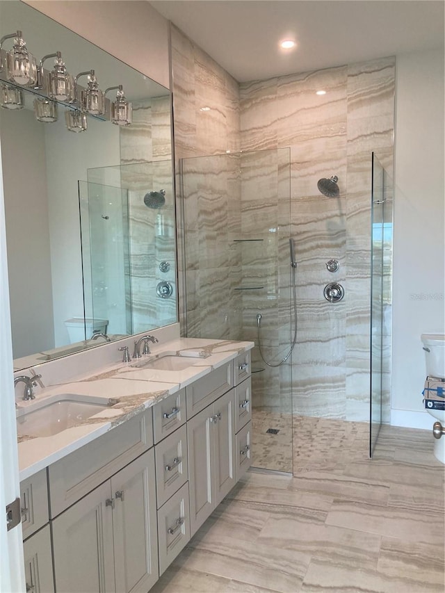 bathroom featuring vanity and a shower with door