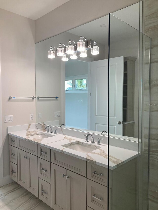 bathroom with a shower with door and vanity